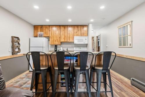 a kitchen with a table and chairs in a room at Mountain Charmer Steps to Main St and Trails in Frisco