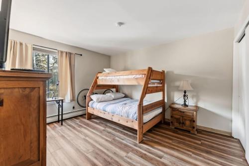 a bedroom with a bunk bed and a desk at Mountain Charmer Steps to Main St and Trails in Frisco