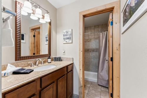 a bathroom with a sink and a shower at Mountain Charmer Steps to Main St and Trails in Frisco