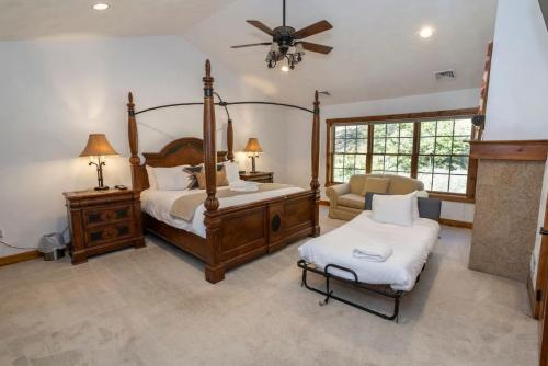 a bedroom with a canopy bed and a chair at Summit Retreat Seven Springs in Champion