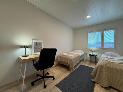 a room with a desk and a bed and a desk sidx sidx sidx at Convenient Apartment for 2 in Kotka