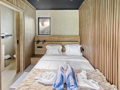 a bedroom with a bed with two towels on it at Villa Byu By Local Property Team in Balian