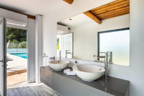two sinks in a bathroom with a mirror at Can Maruna in Sant Joan de Labritja