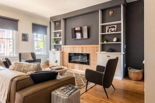 a living room with a couch and a fireplace at The Lancastrian House Downtown in Lancaster