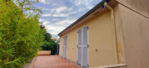 a building with two garage doors on the side of it at Gîte Ilostou in Rivière