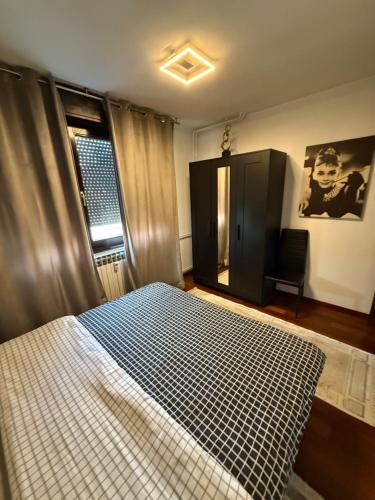 a bedroom with a bed and a chair and a window at Rita Apartment-FREE PARKING&WIFI in Zagreb