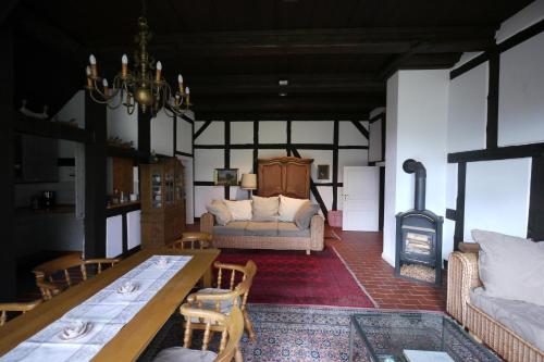 a living room with a couch and a fireplace at Deelenwohnung in Trebel