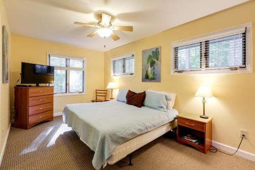 a bedroom with a bed and a flat screen tv at Dock, Views and Fire Pit Retreat on Lake Norman in Webbs