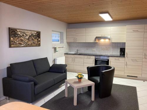 a living room with a couch and a table at Fewo Marina Beha in Unterkirnach