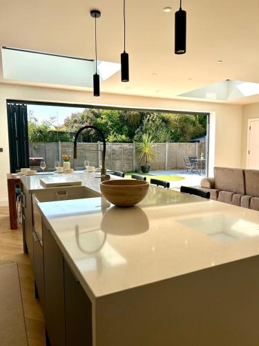 a kitchen with a counter with a sink and a counter top at The Crescent Villa Lancing in Lancing