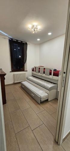 two beds in a room with a tile floor at Casa Vacanze "La Laguna Incantata" con 6 posti letto in Comacchio