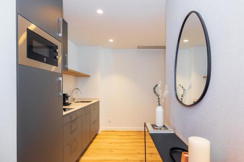 a bathroom with a sink and a mirror at Brabo Apartments in Hospitalet de Llobregat