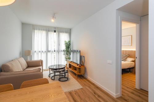 a living room with a couch and a table at Brabo Apartments in Hospitalet de Llobregat