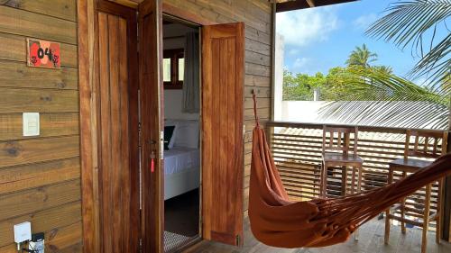 a hammock on the porch of a house at Estação Orgânica Taipu in Marau