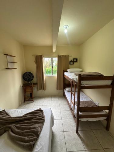 Ένα ή περισσότερα κρεβάτια σε δωμάτιο στο Vila das Dunas - Santinho