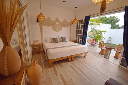 a bedroom with a bed and a large window at Casa Nomis Cancun in Cancún