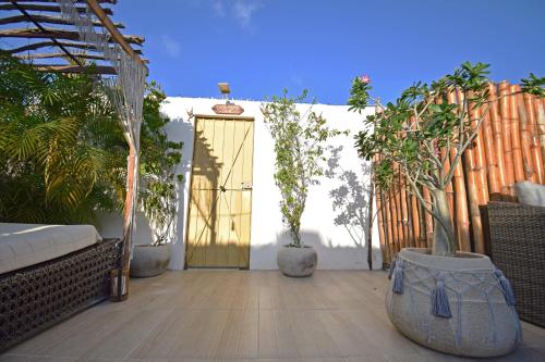 a patio with a door with potted plants on it at Casa Nomis Cancun in Cancún