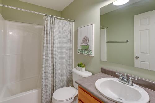 a bathroom with a sink and a toilet and a shower at Private Yard and Pond Views Fort Wayne Family Home! in Arcola