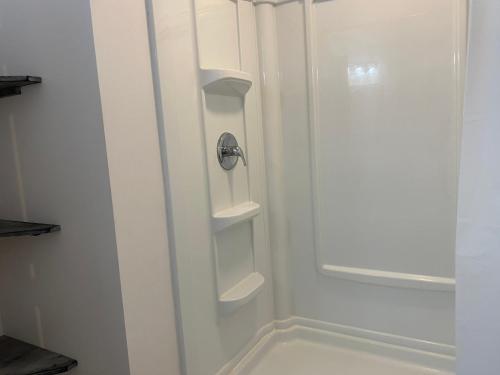 a white shower with shelves in a bathroom at Suite in Lakeside house in Alpharetta