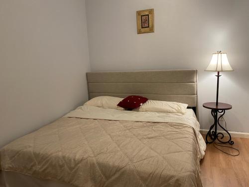 a bedroom with a bed with a red hat on it at Suite in Lakeside house in Alpharetta
