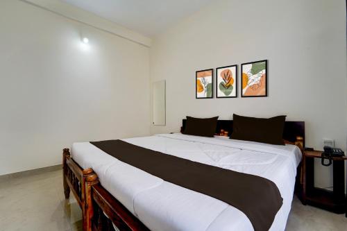 a bedroom with a large bed in a room at Collection O Govt Engineering College Formerly Anby Plaza in Trivandrum