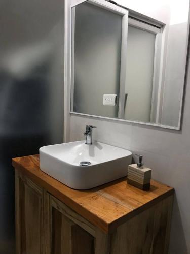 a bathroom with a white sink and a mirror at Ayampe Sunrise in Ayampe