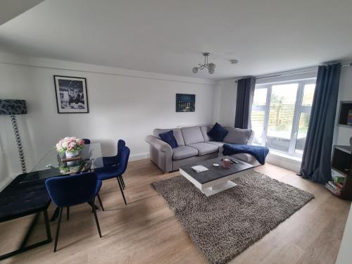 a living room with a couch and a table at Spacious 3BR Home with Large Garden - Ashford, Kent in Kennington