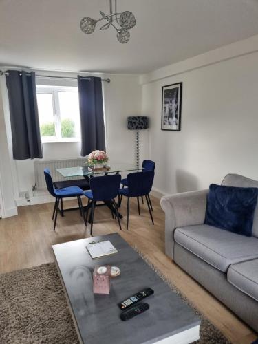 a living room with a couch and a table at Spacious 3BR Home with Large Garden - Ashford, Kent in Kennington