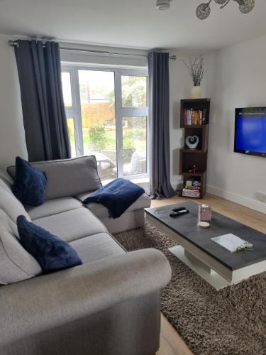 a living room with a couch and a coffee table at Spacious 3BR Home with Large Garden - Ashford, Kent in Kennington