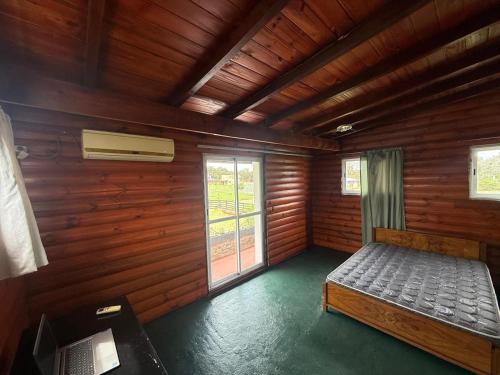a bedroom with a bed in a wooden room at CASA Barrio Parque Mar in Miramar