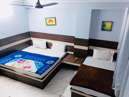 a bedroom with two beds in a room at Hotel Churu Palace in Jaipur