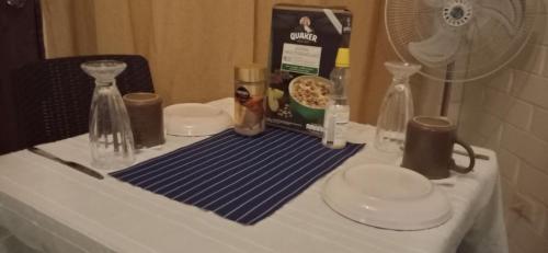 a table with a blue and white table cloth and bottles at Alojamiento Rústic in Santiago