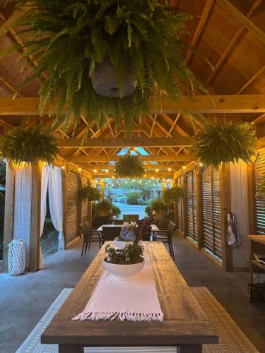 a large room with a table with plants on it at Cape Cod Veranda in South Yarmouth