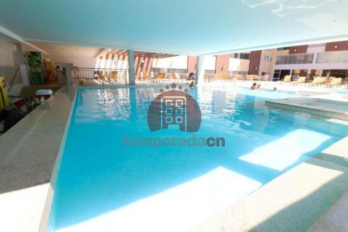 a swimming pool with a sign on the side of it at Piazza com Acesso ao Acqua Park - Temporada CN in Caldas Novas