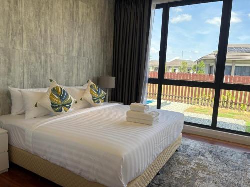 a bedroom with a large bed with a large window at The Mangrove at Carey Circles 