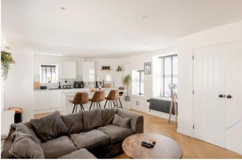 a living room with a couch and a kitchen at Entire house, close to central Bristol in Bristol
