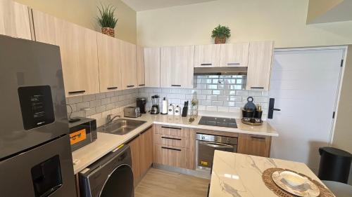 a small kitchen with a sink and a stove at Apartment Luxury ONA Residence, Punta Cana in Punta Cana