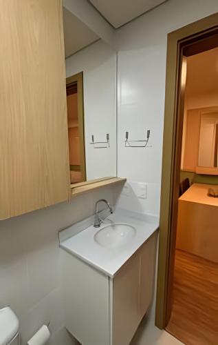 a bathroom with a sink and a mirror at Centenário in Santa Maria