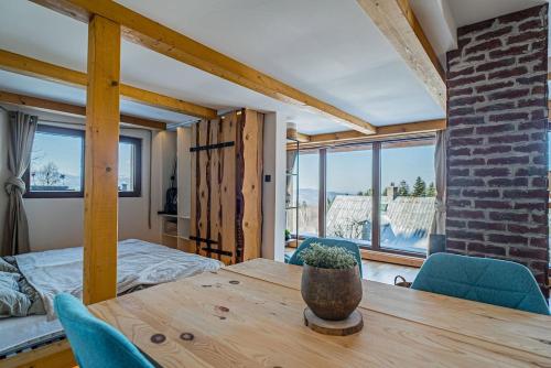 a room with a table and chairs and a bedroom at Chata Malenovice in Malenovice