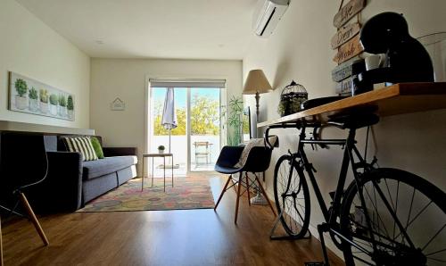 a living room with a bike parked in a room at Fascinante Orbita Apartments in Vila Nova de Famalicão