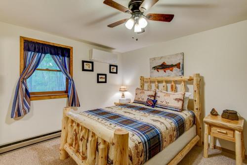 a bedroom with a wooden bed and a ceiling fan at Banner Bunks at River Run in Banner Elk