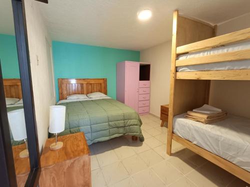 a bedroom with two bunk beds and a lamp at Jardin 85 Hostel in Morelia