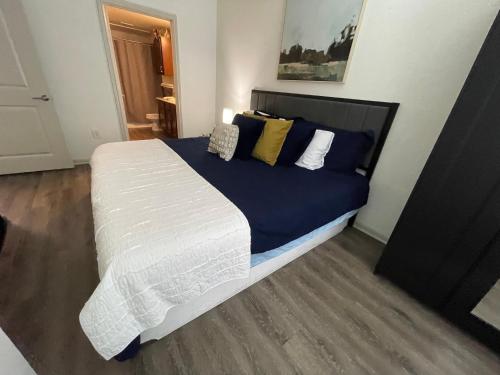 a bedroom with a large bed with blue and yellow pillows at Centrally-Located 1BR Suite with Resort Pool View in Frisco