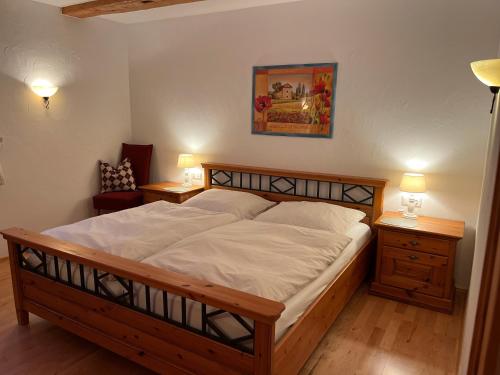 a bedroom with a large bed and two night stands at Ferienwohnung Lindenhof in Lenzkirch