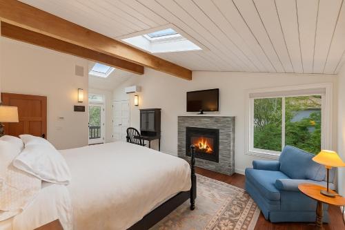 a bedroom with a bed and a fireplace at The Retreat at River Gardens in Monte Rio