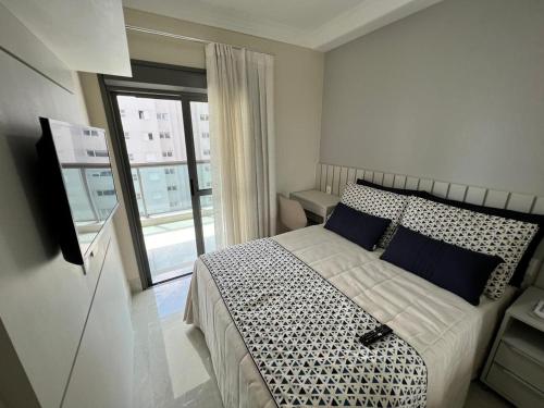 Voodi või voodid majutusasutuse Home 48 I Apto pé na areia e com Piscina Aquecida em Bertioga toas