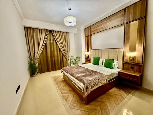 a bedroom with a large bed with green pillows at Deira Luxurious unit near metro in Dubai