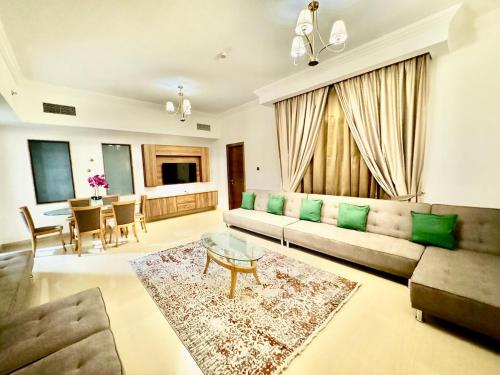 a living room with a couch and a table at Deira Luxurious unit near metro in Dubai