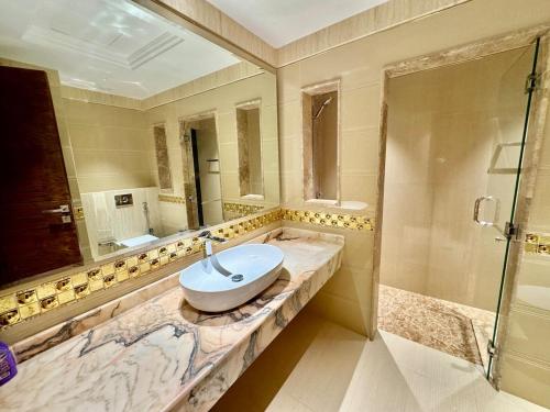 a bathroom with a sink and a shower at Deira Luxurious unit near metro in Dubai
