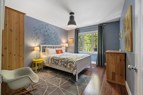 a bedroom with a bed and a chair and a window at The Sandy Star in Guerneville